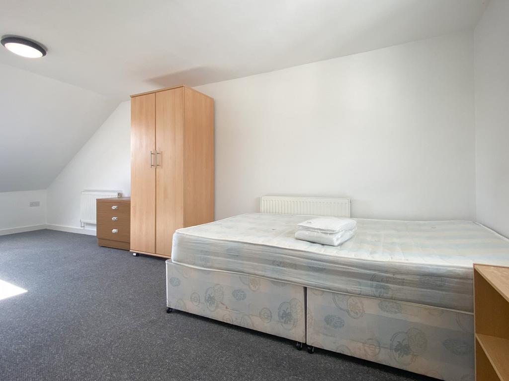 Bright, neutrally decorated double bedroom with...
