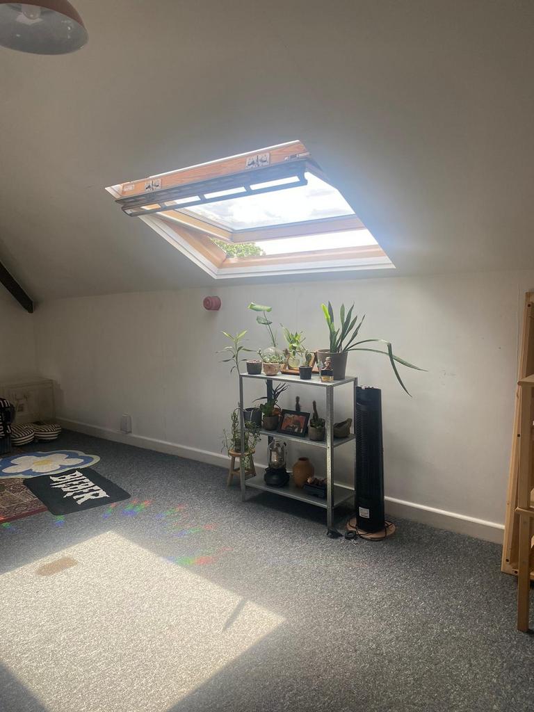 Bright attic double bedroom with a large skylig...