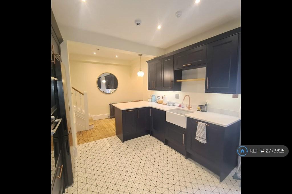 Kitchen With Large Butler Sink And Appliances