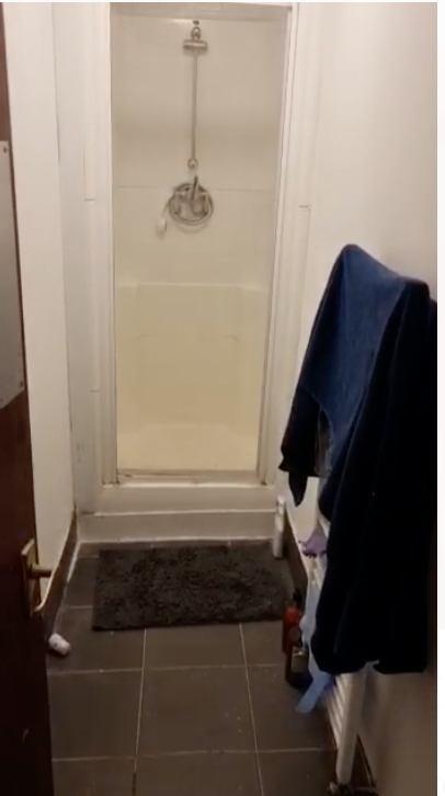 Compact bathroom featuring a shower space with ...