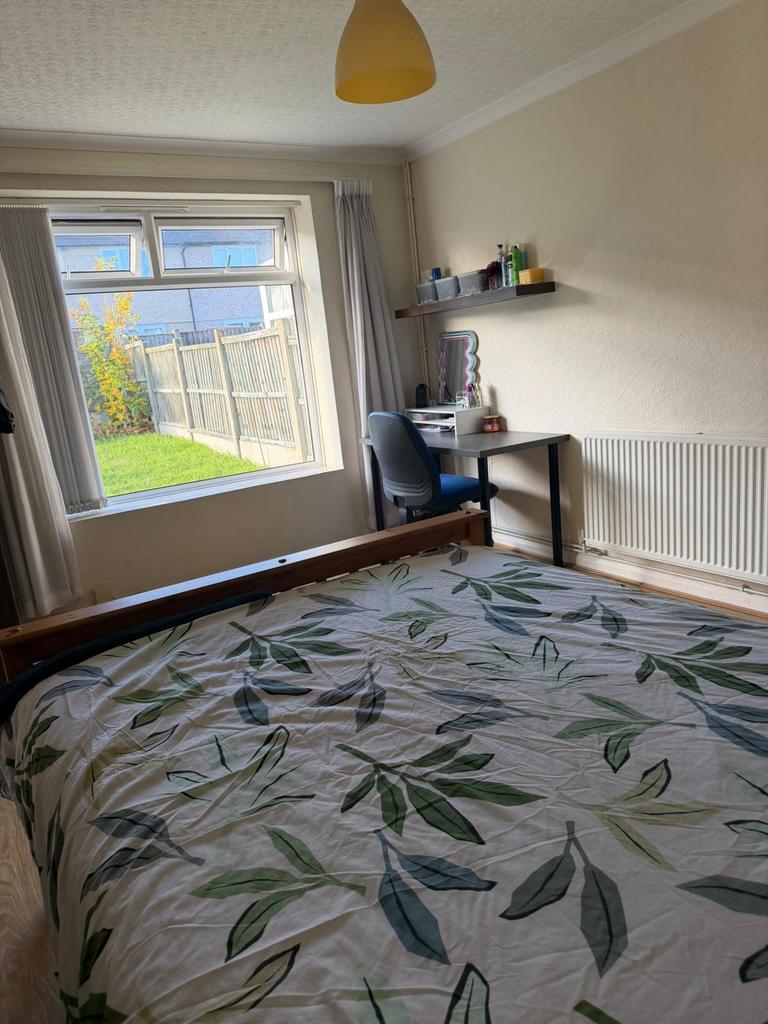 Bright bedroom with a large window overlooking ...