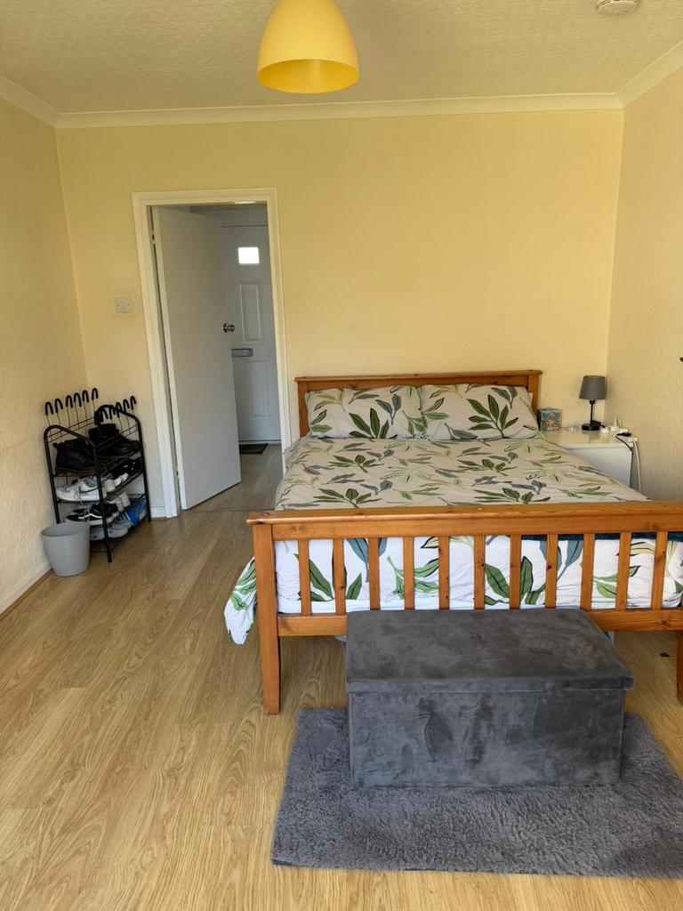 Bright, neatly presented bedroom with wooden do...