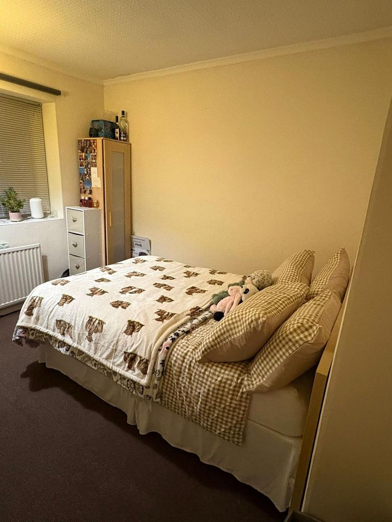 Cozy double bedroom with a comfortable bed dres...