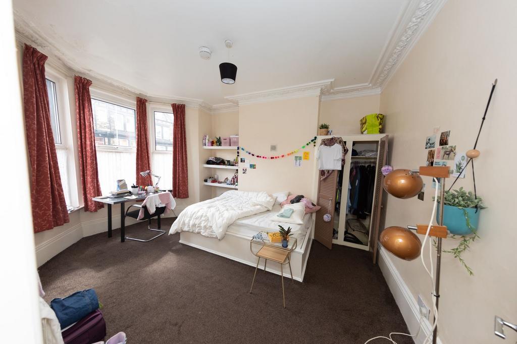 Bright and welcoming bedroom with large windows...