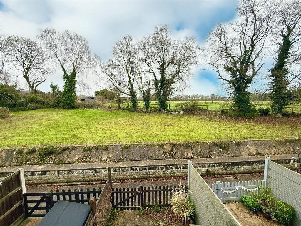 View over communal grounds to farm land beyond