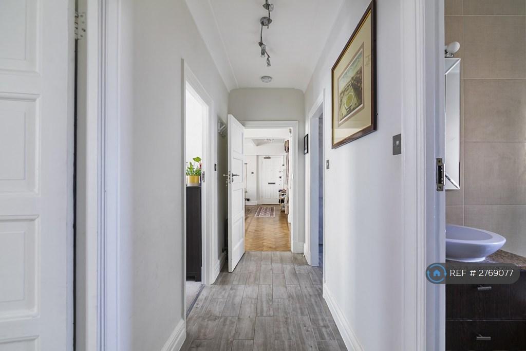 Hallway Leading To The Rooms And Kitchen