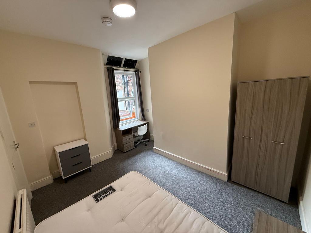 Bright, simply furnished double bedroom with a ...