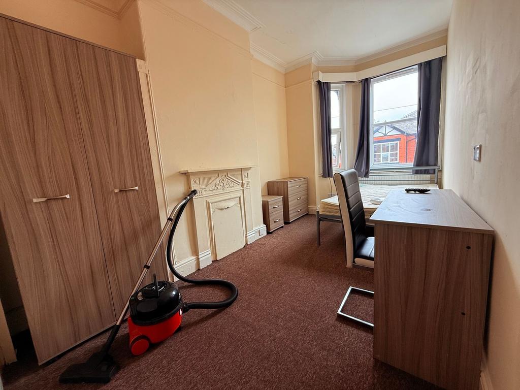 Bright front-facing bedroom with a bay window, ...