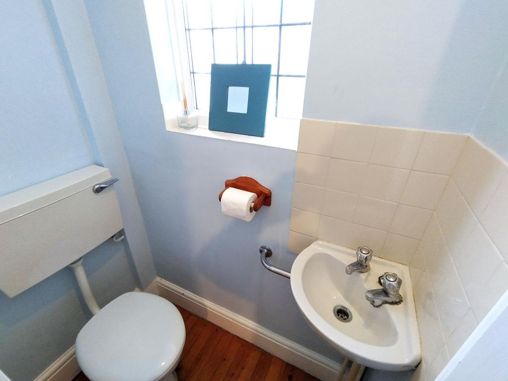 Neat and bright WC with a compact corner washba...