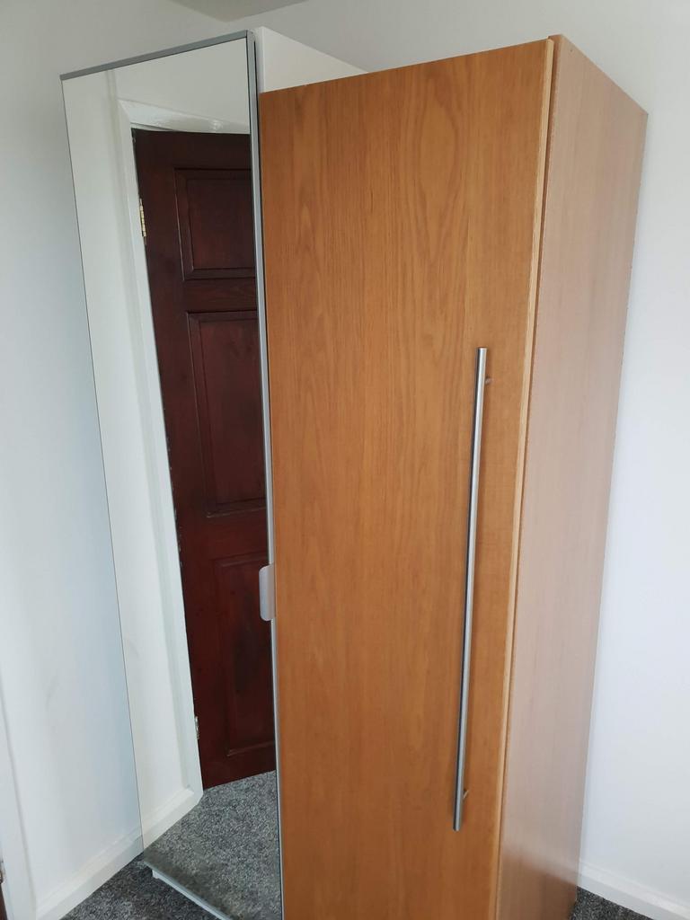 Tall wooden wardrobe with a full-length mirrore...