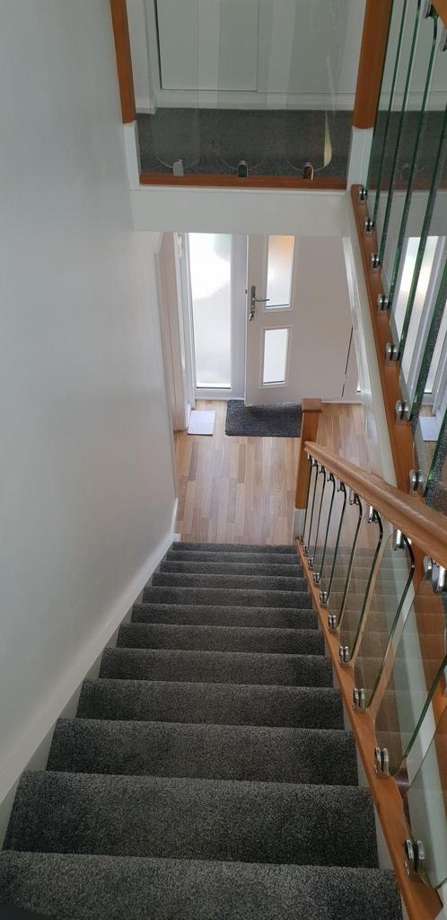 Bright, modern stairwell with fresh grey carpet...
