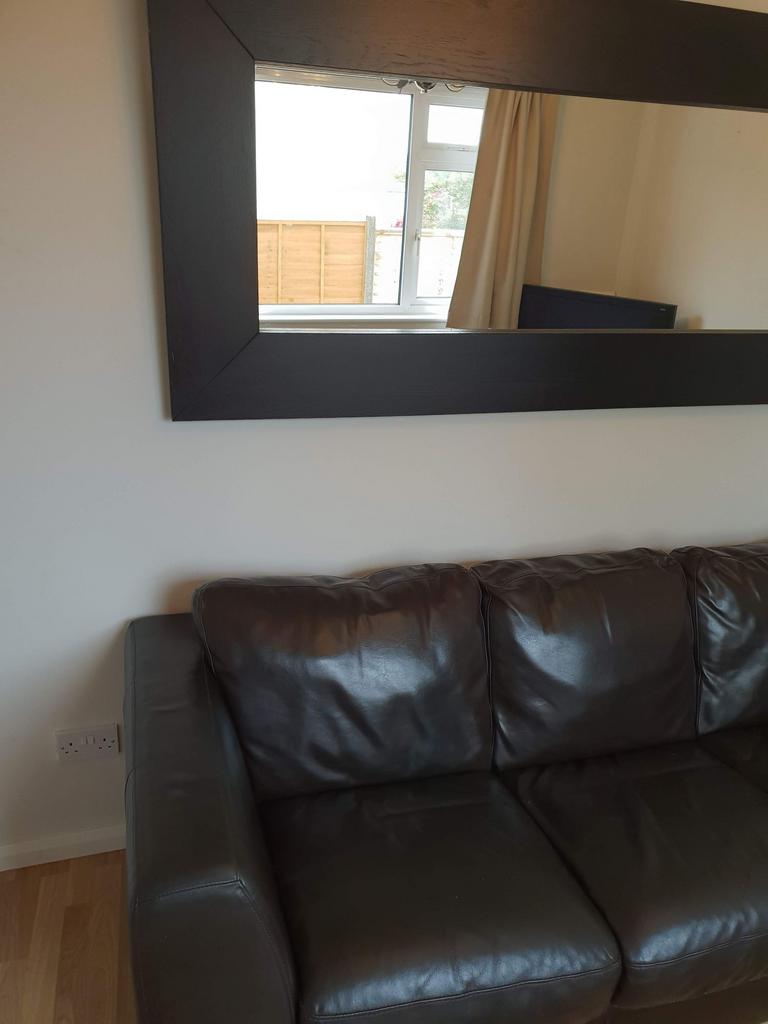 Bright, neatly presented living area with a com...