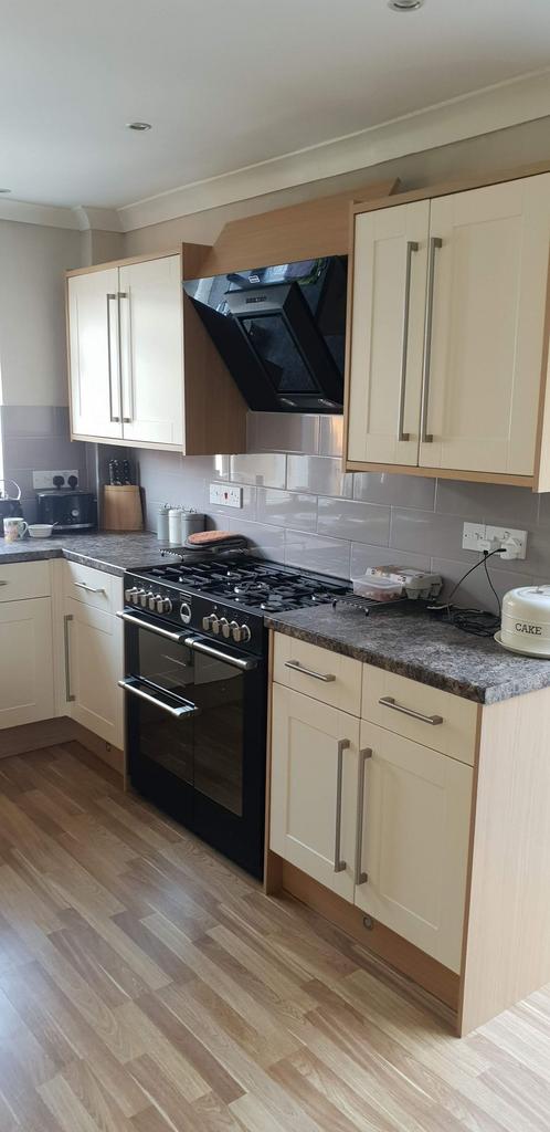 Bright modern kitchen with cream shaker-style c...