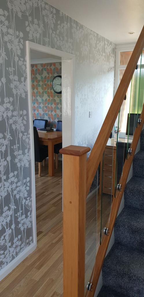 Bright, modern hallway with patterned wallpaper...