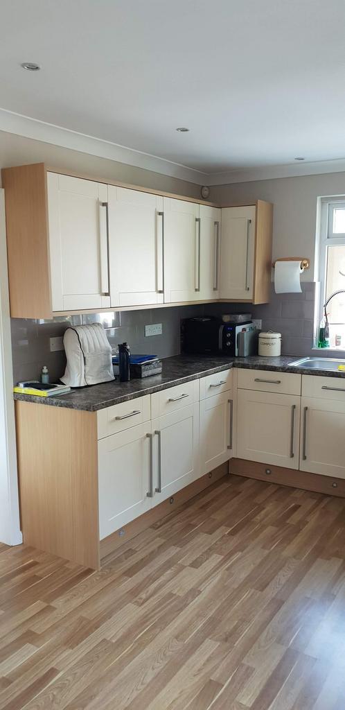 Bright, modern kitchen with light wood cabinetr...