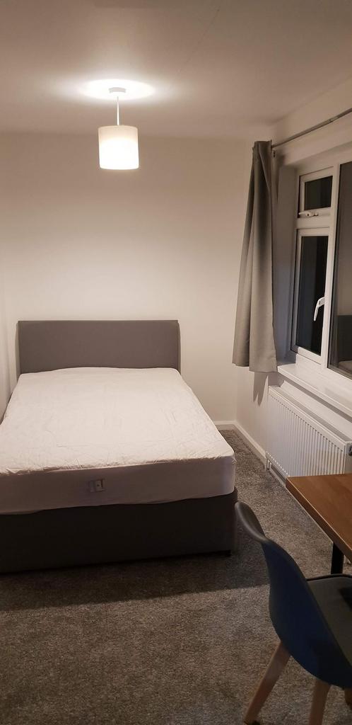 Bright, neatly presented bedroom with a comfort...