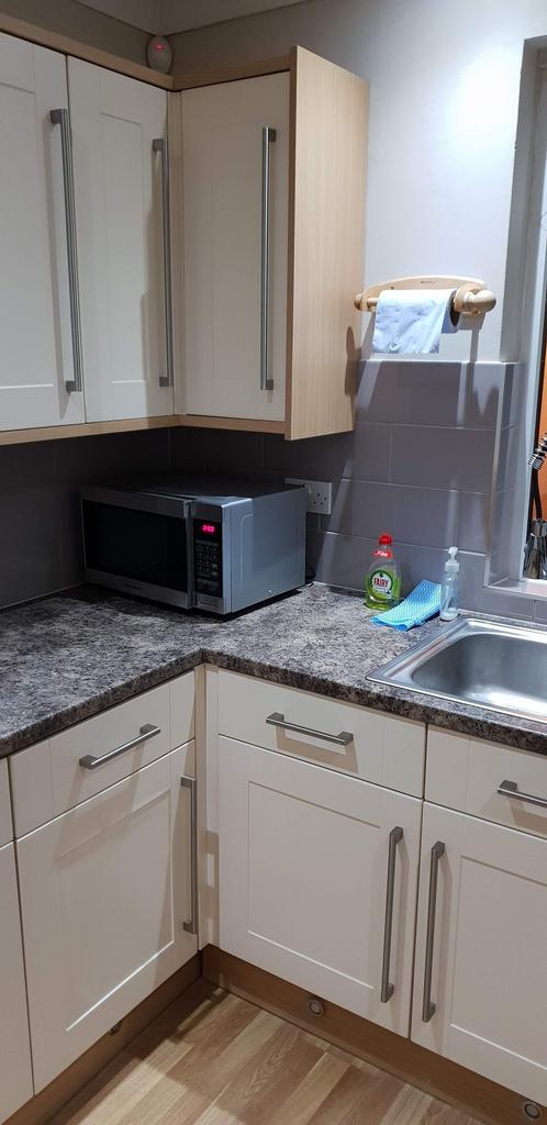 Bright, modern kitchen corner with clean lamina...