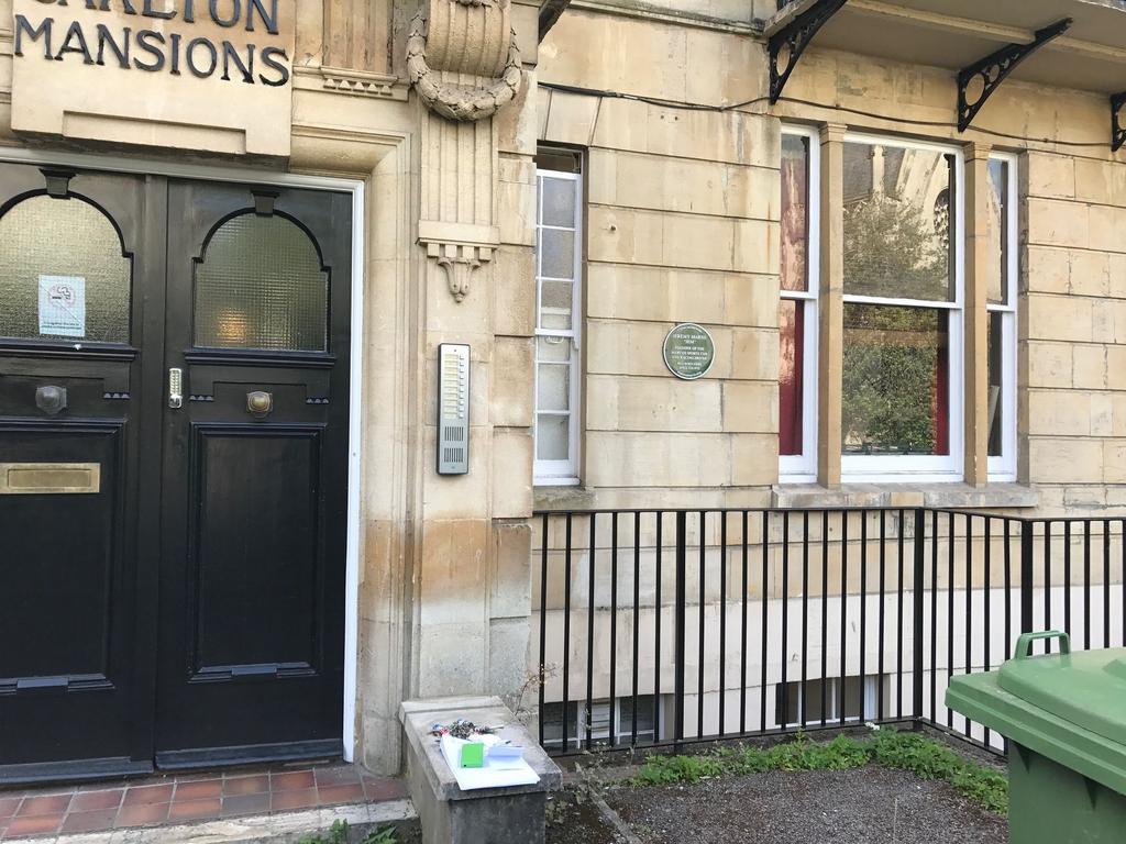 Stone-fronted period building entrance with dar...