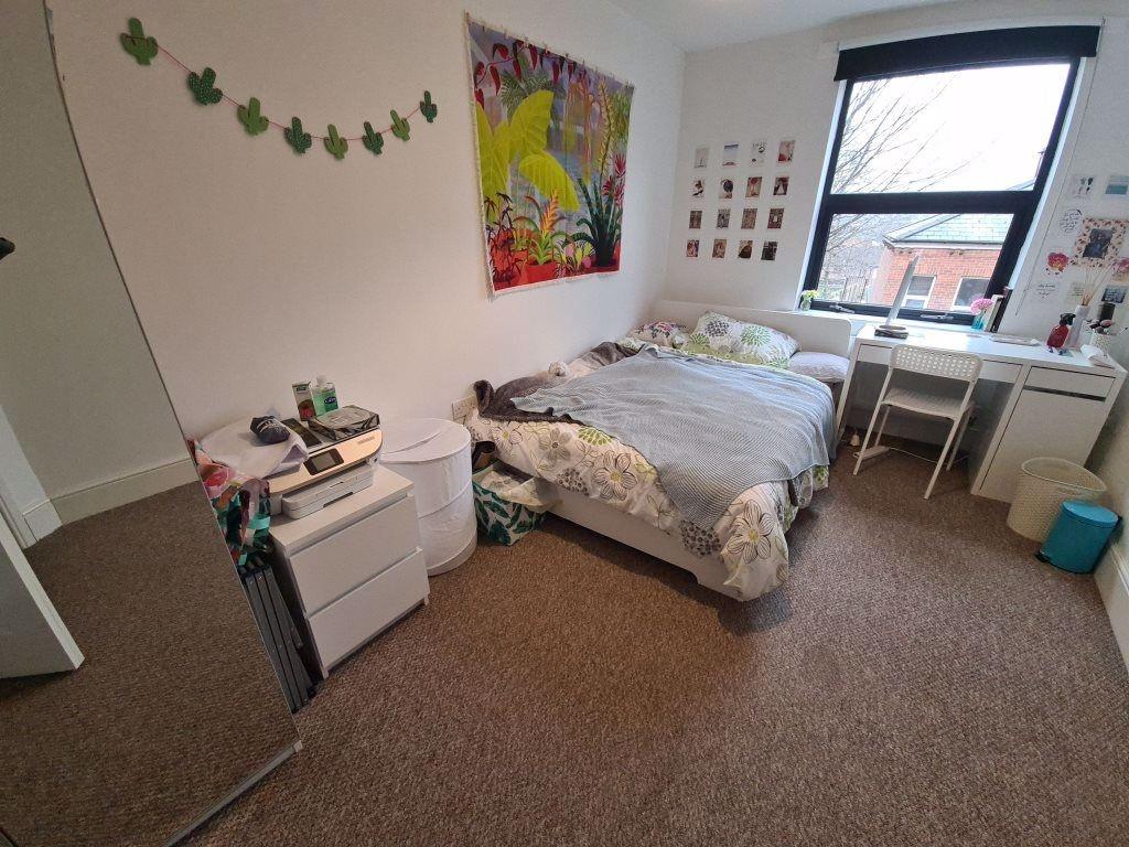 A cozy double bedroom featuring a comfortable d...