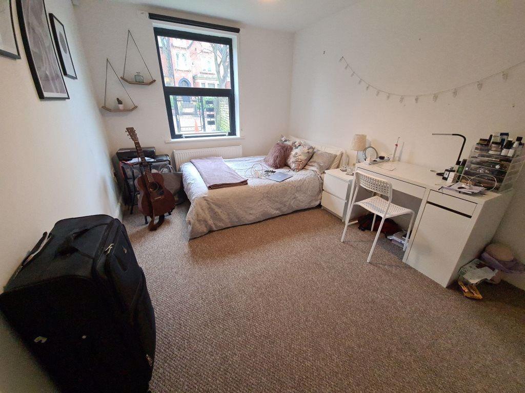 Cozy single bedroom featuring a comfortable bed...