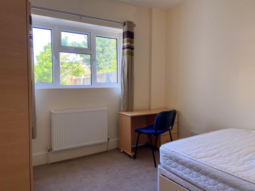 Bright, tidy single bedroom with a large window...