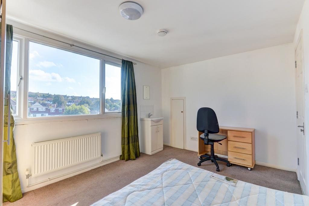 Bright double bedroom with a large window offer...