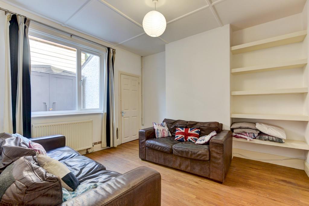 A bright and welcoming living room with ample n...