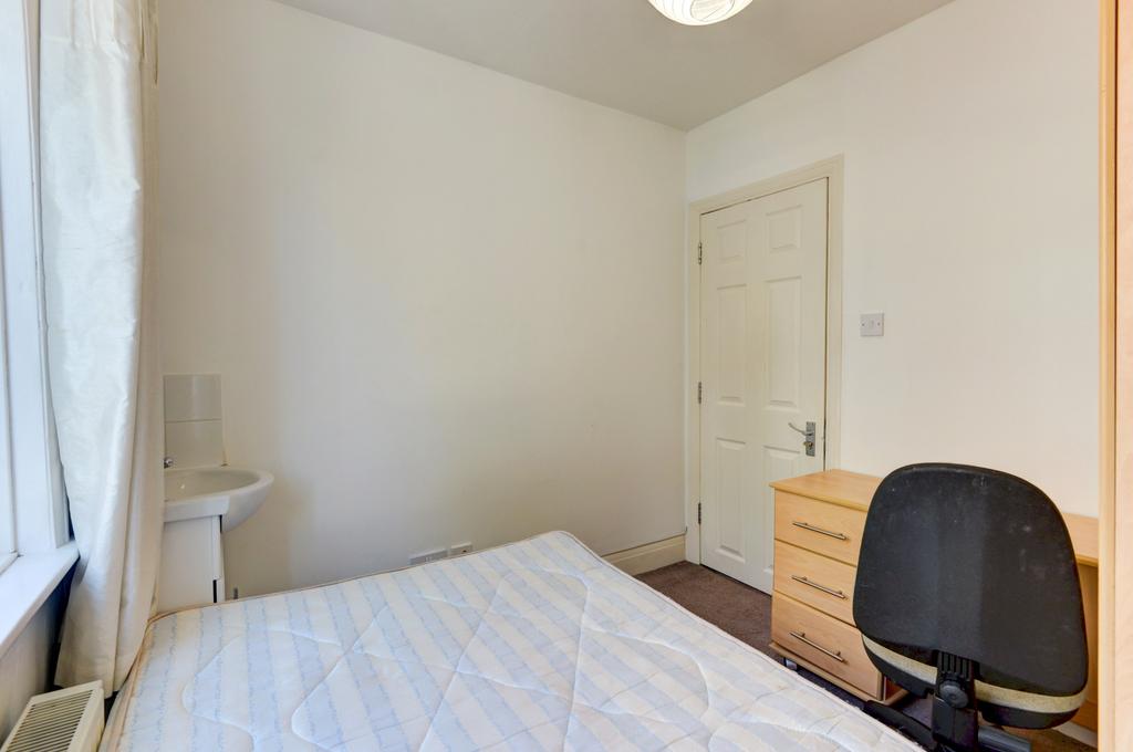 A bright and inviting bedroom featuring a neatl...