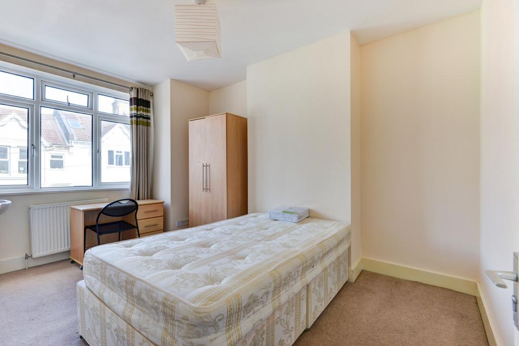 Bright single bedroom with a large window, simp...