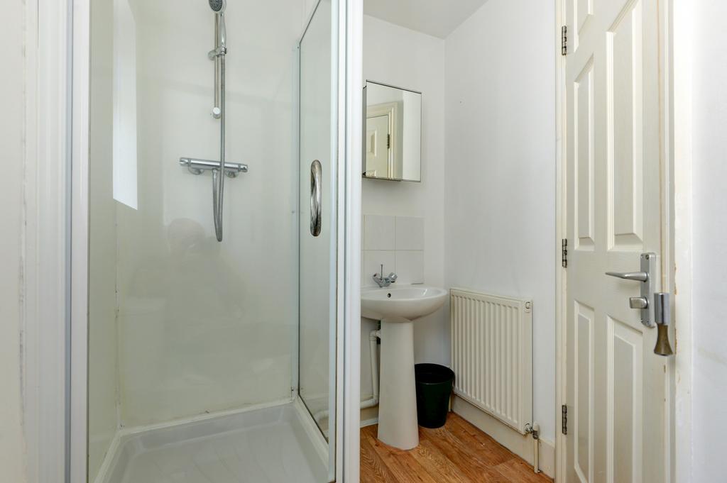 Neat bathroom with a corner shower enclosure, p...