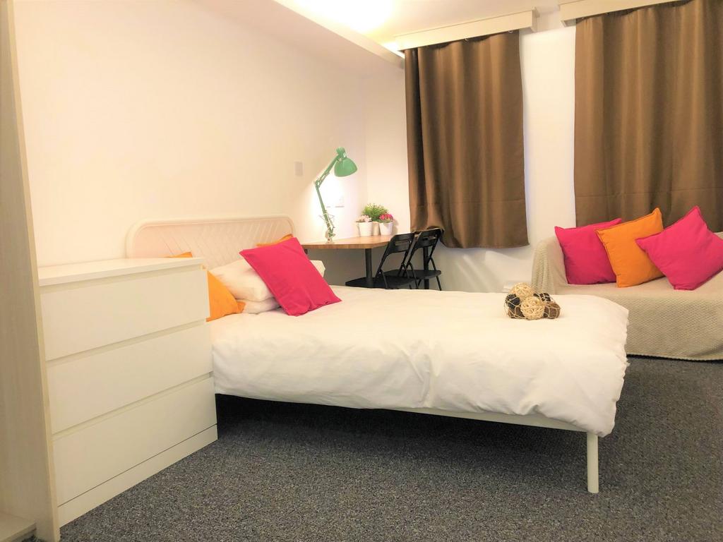 Bright and welcoming master bedroom featuring a...