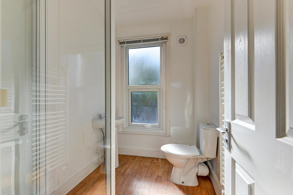 Bright, modern bathroom with a large walk-in gl...