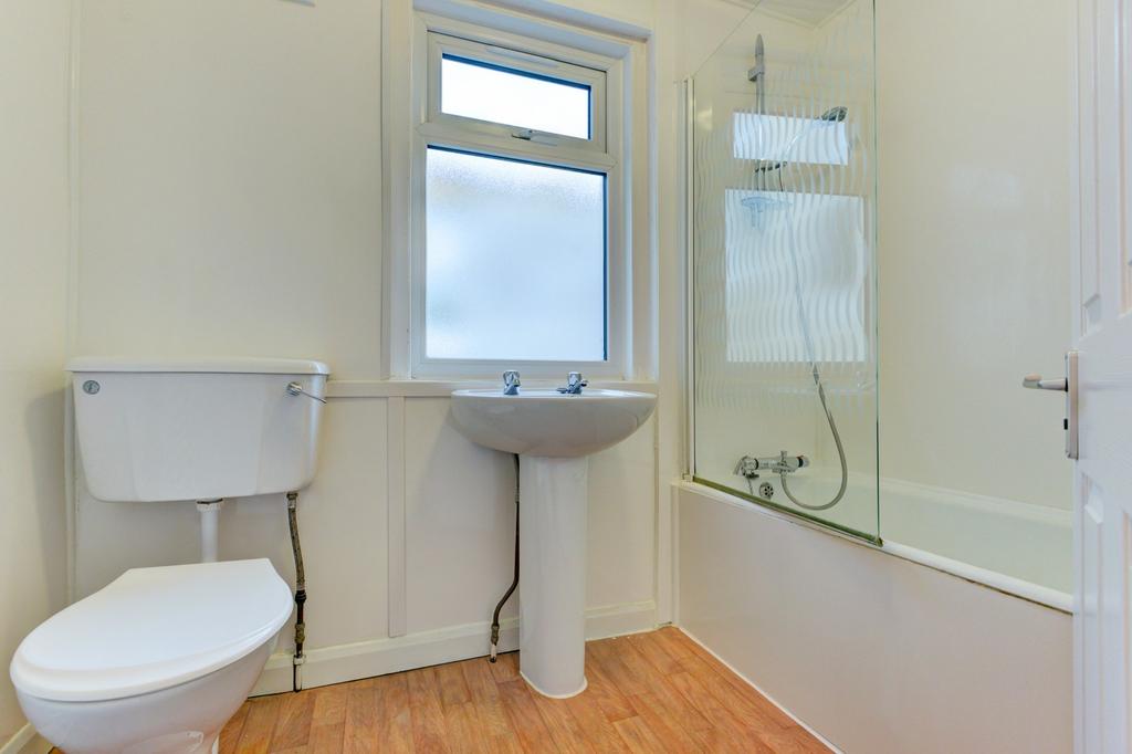 Bright, well-maintained bathroom with a bathtub...