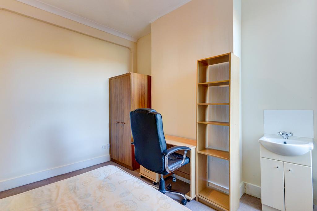 Bright, simply furnished bedroom with wardrobe,...