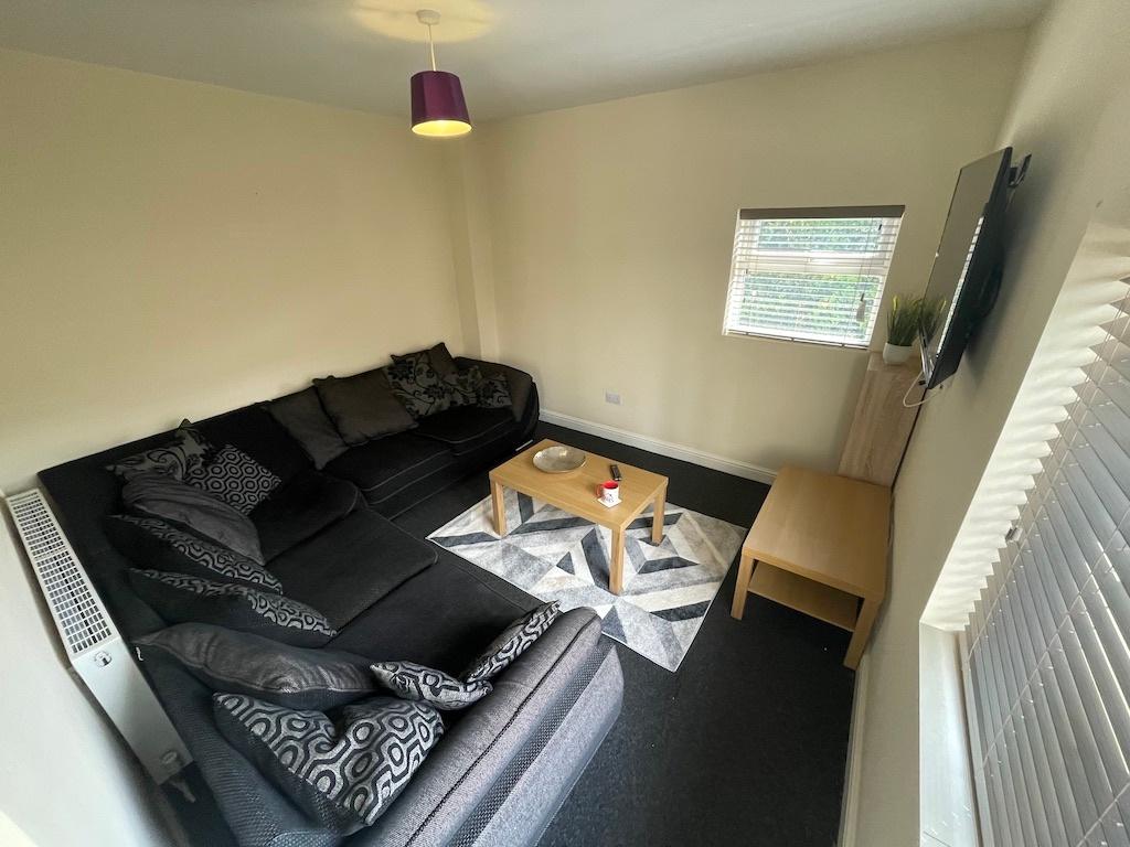 Bright corner living room with a large L-shaped...