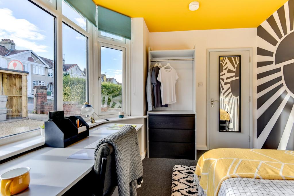 Bright, stylish bedroom with a large bay window...