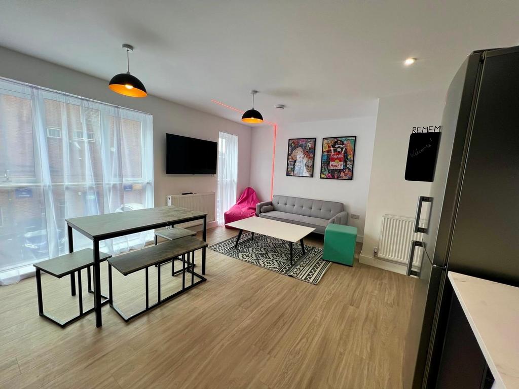 Bright, modern open-plan living area with large...