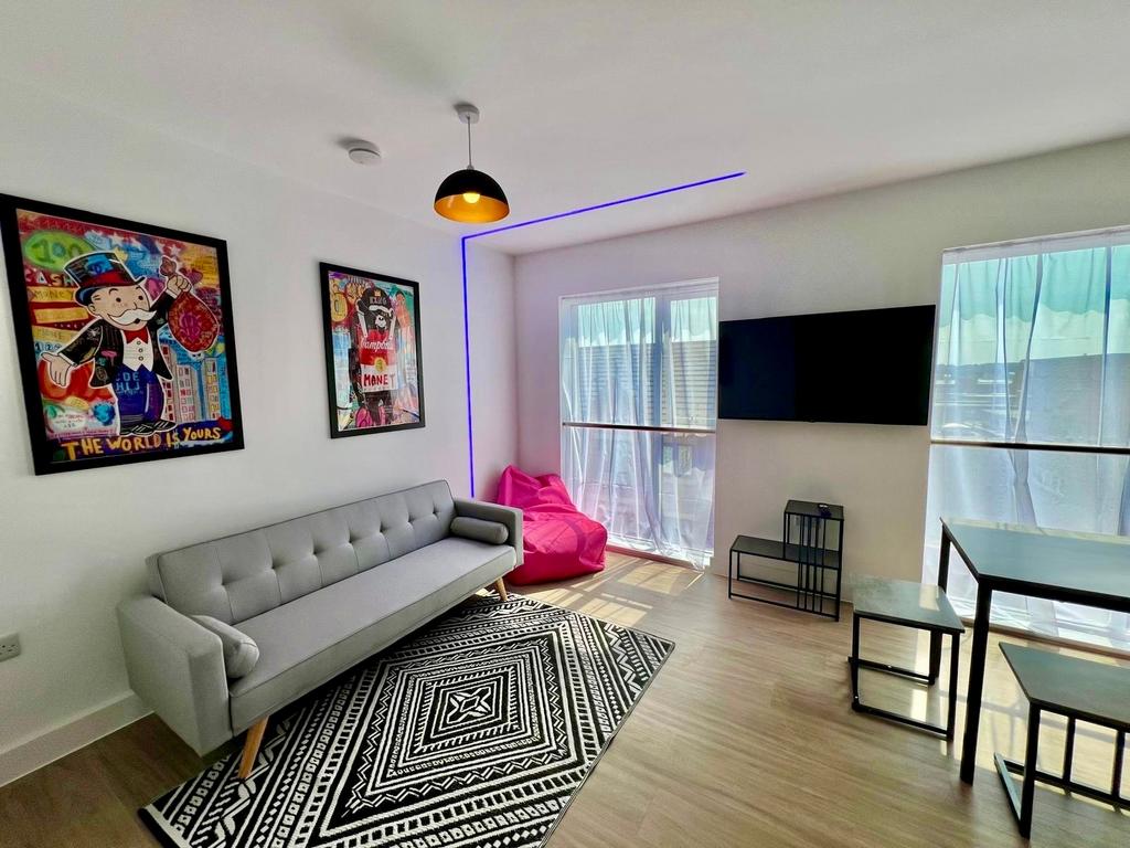 Bright, modern living room with sleek grey sofa...