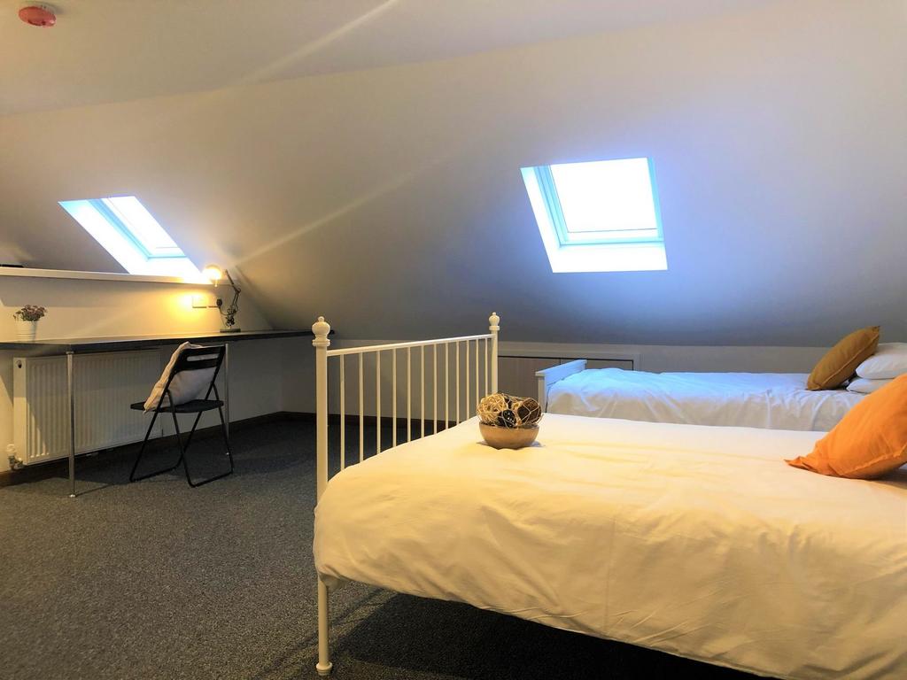 Bright and cozy double bedroom featuring two co...