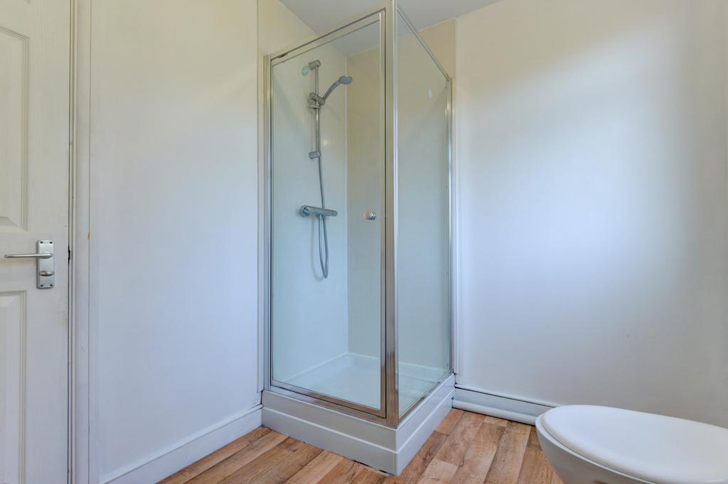 A clean and modern bathroom with a clear glass ...