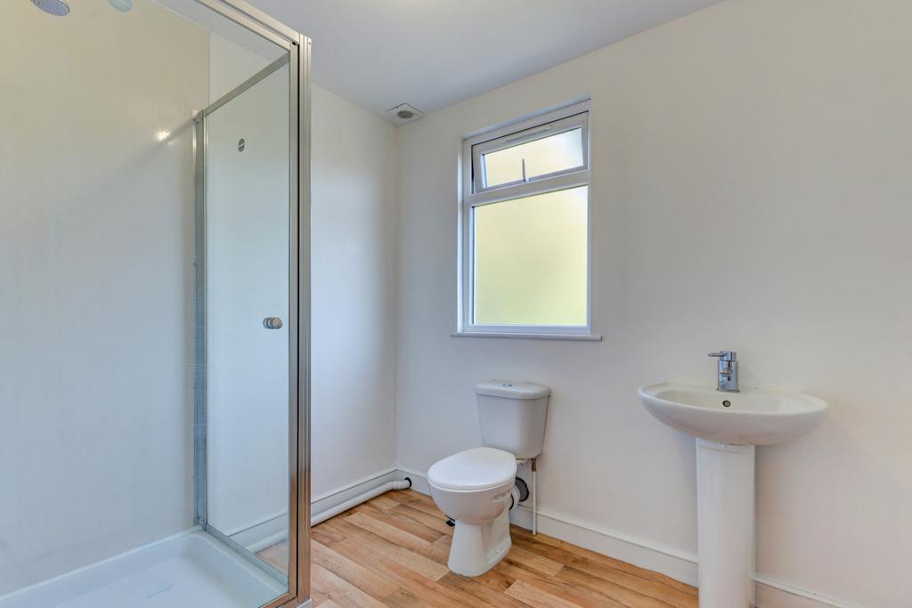 A clean and bright bathroom featuring a shower ...