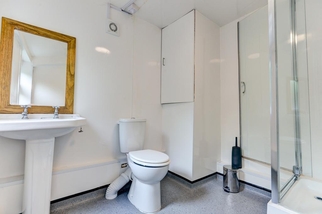 Bright, modern bathroom with a walk-in shower, ...