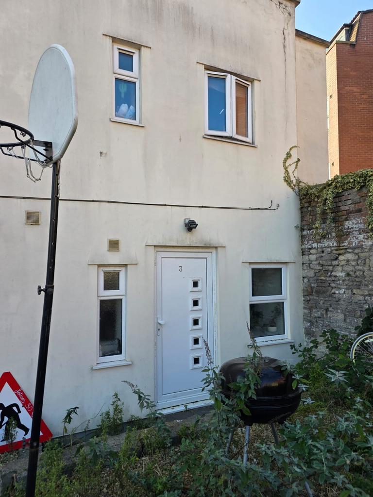 Street-level view of a two-storey rendered prop...