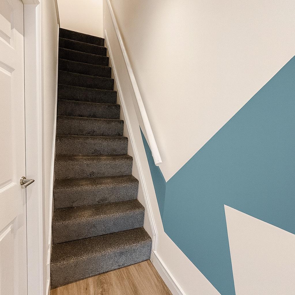 Carpeted indoor staircase with a clean grey run...