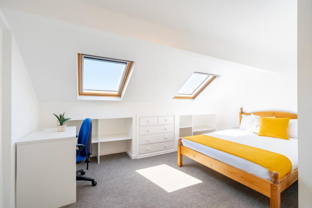 Bright attic double bedroom with two skylights,...