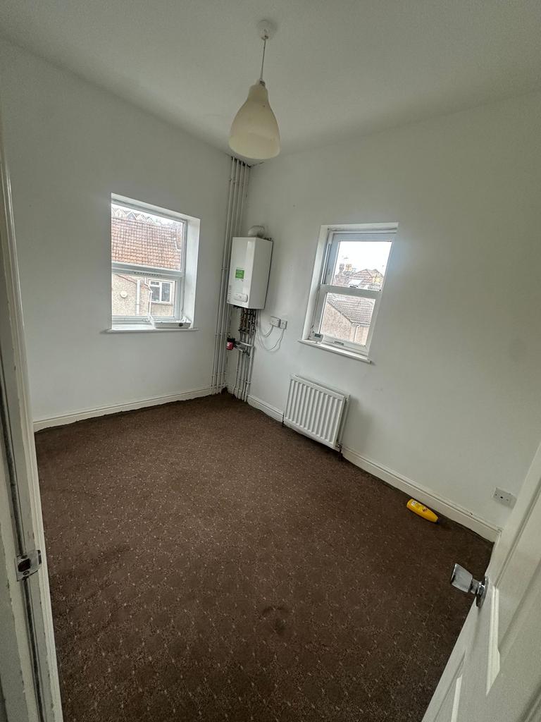 Bright upstairs bedroom with two windows, neutr...