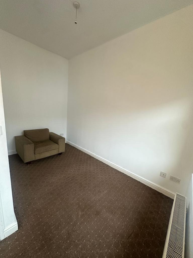 Simple living space with neutral painted walls,...