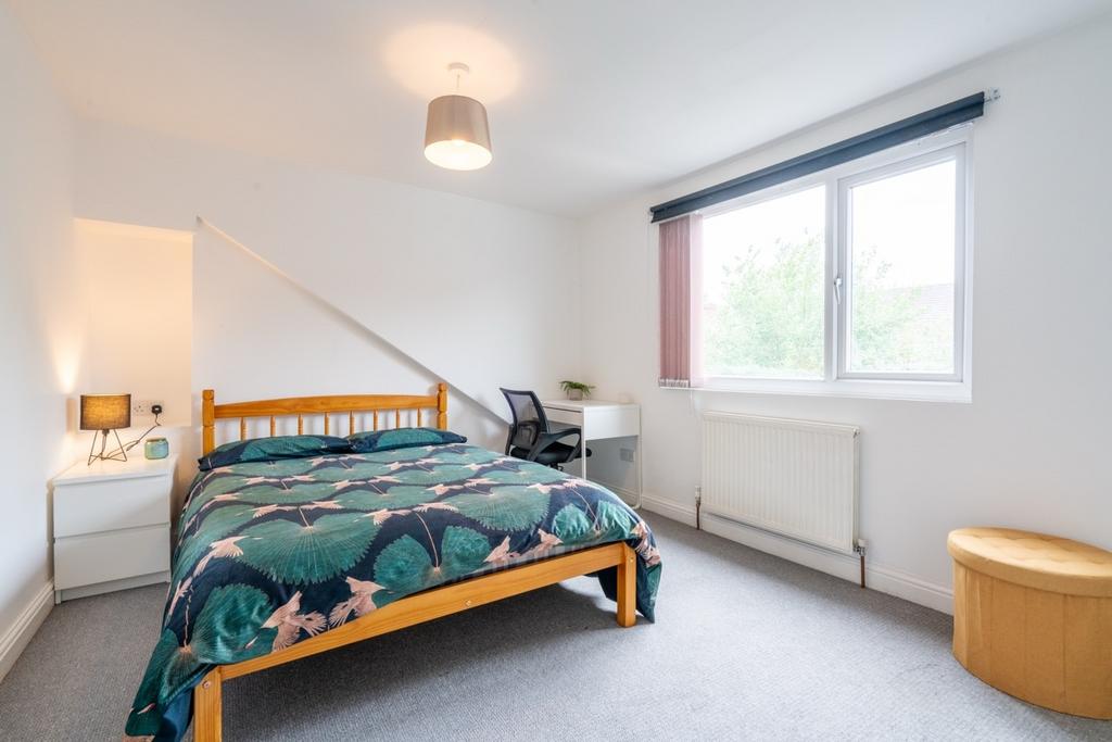 Bright and welcoming bedroom featuring a double...