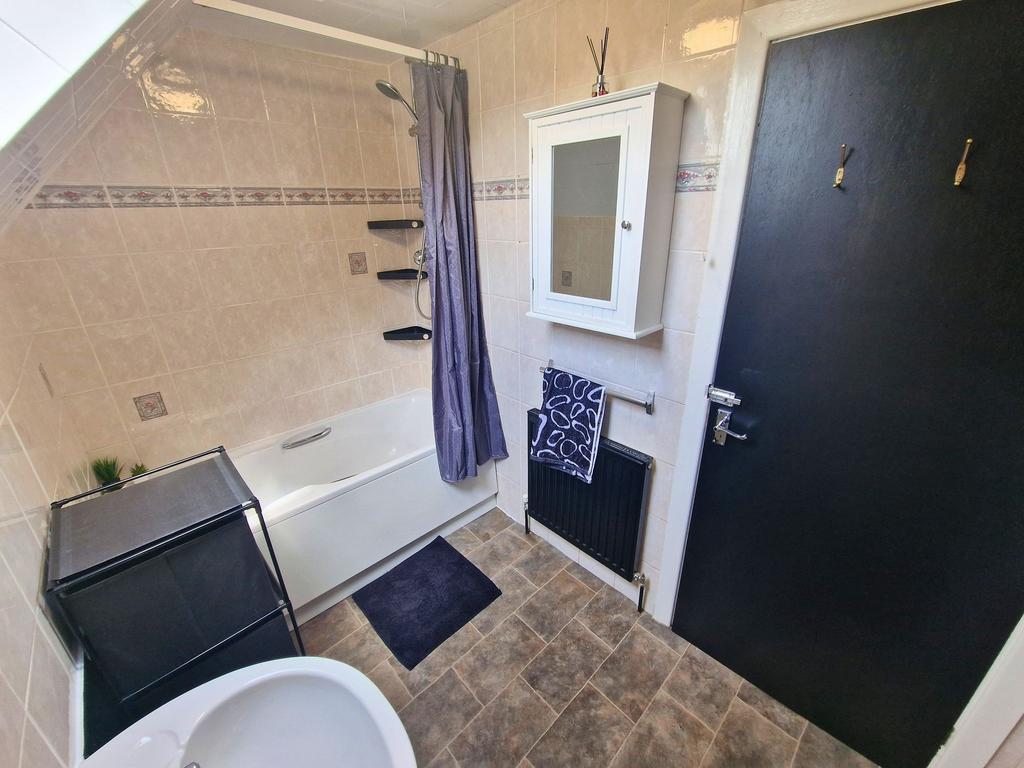 Well-kept bathroom with a modern white bath and...
