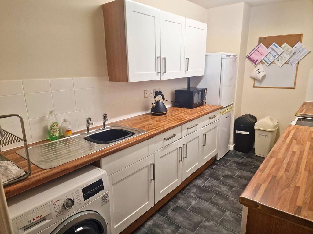Bright, modern galley kitchen with wood-effect ...